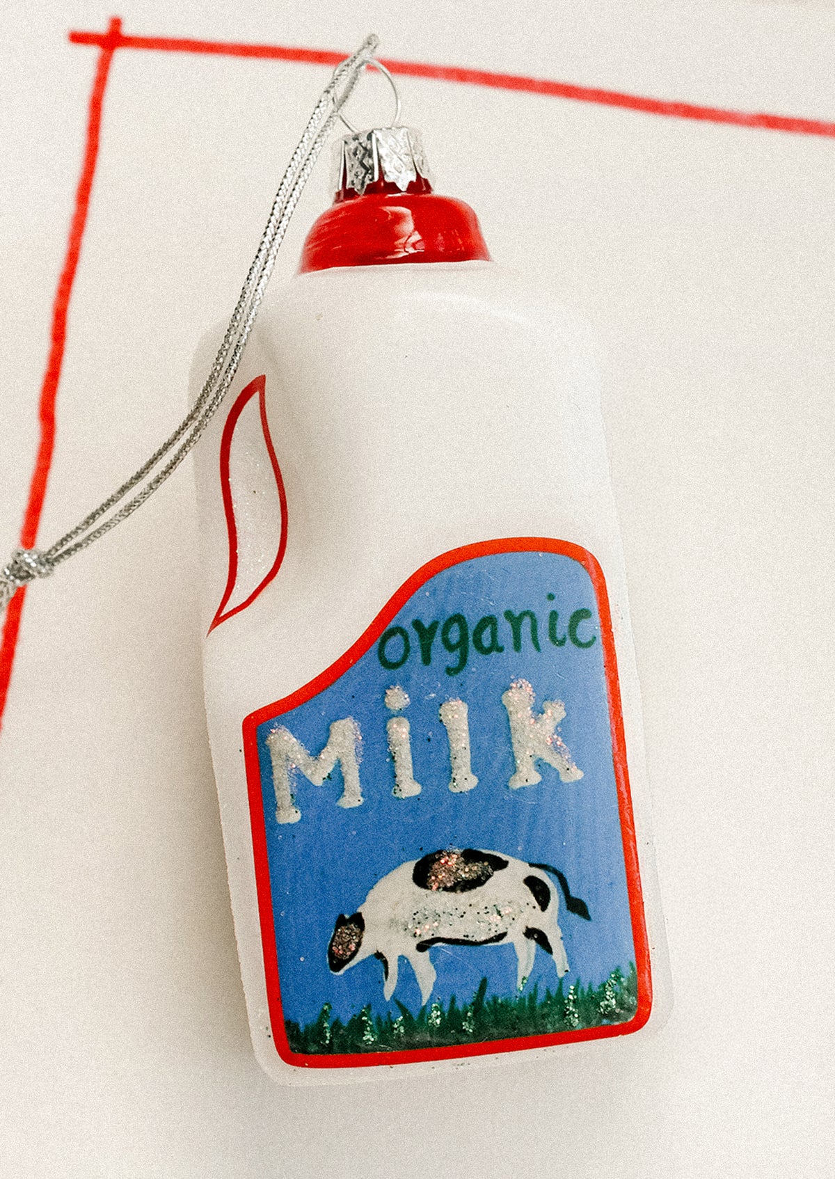 A holiday ornament depicting a carton of organic milk.
