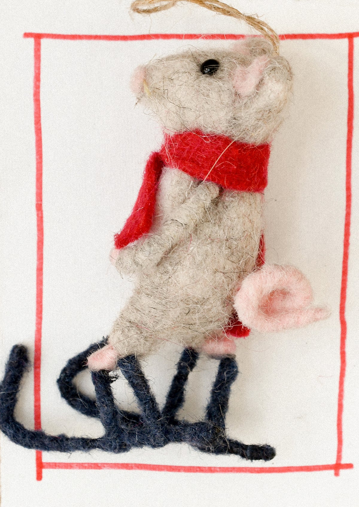 A decorative ornament of a mouse on skis.