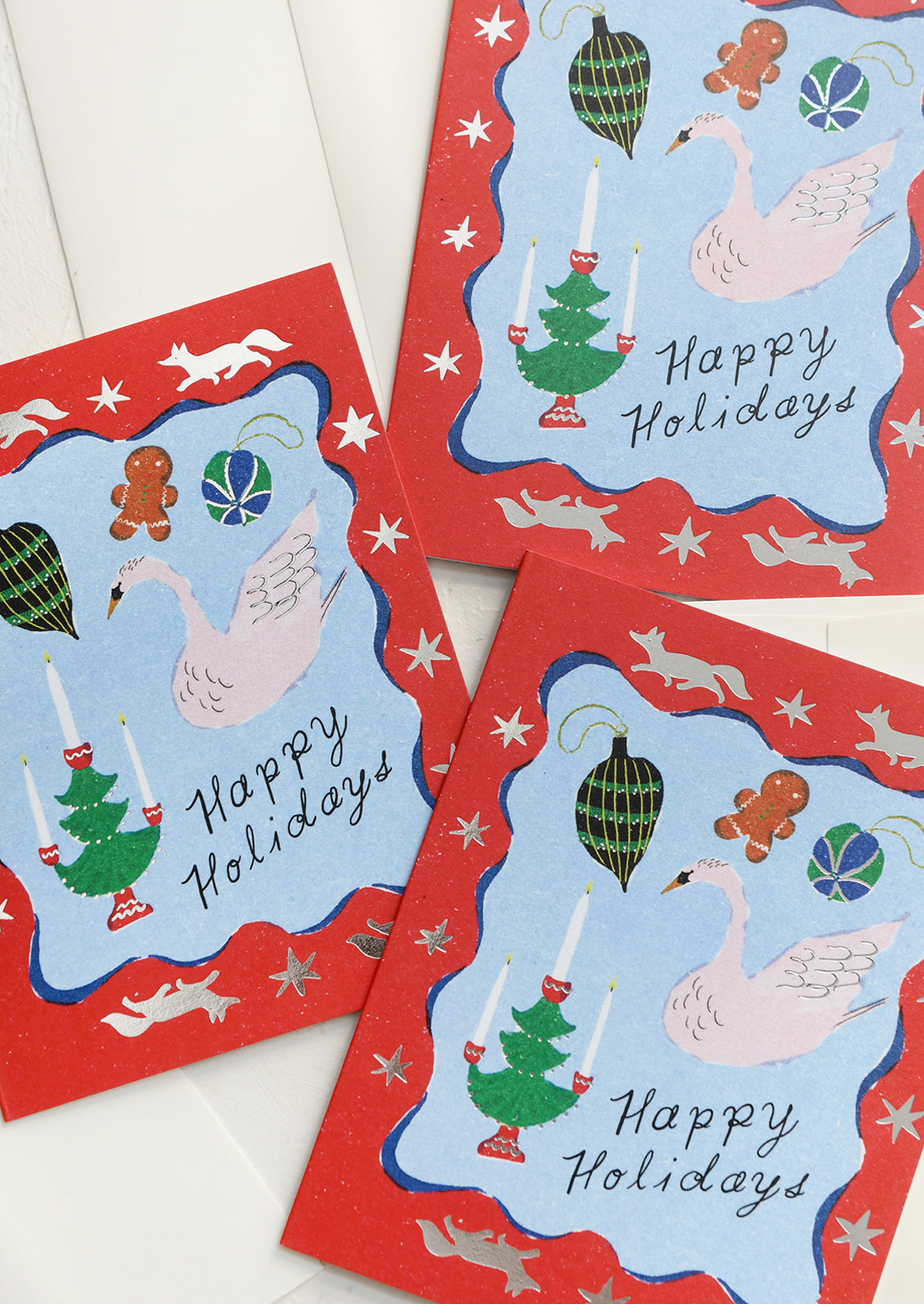 A set of holiday greeting cards with illustrated design, text reads "Happy Holidays".