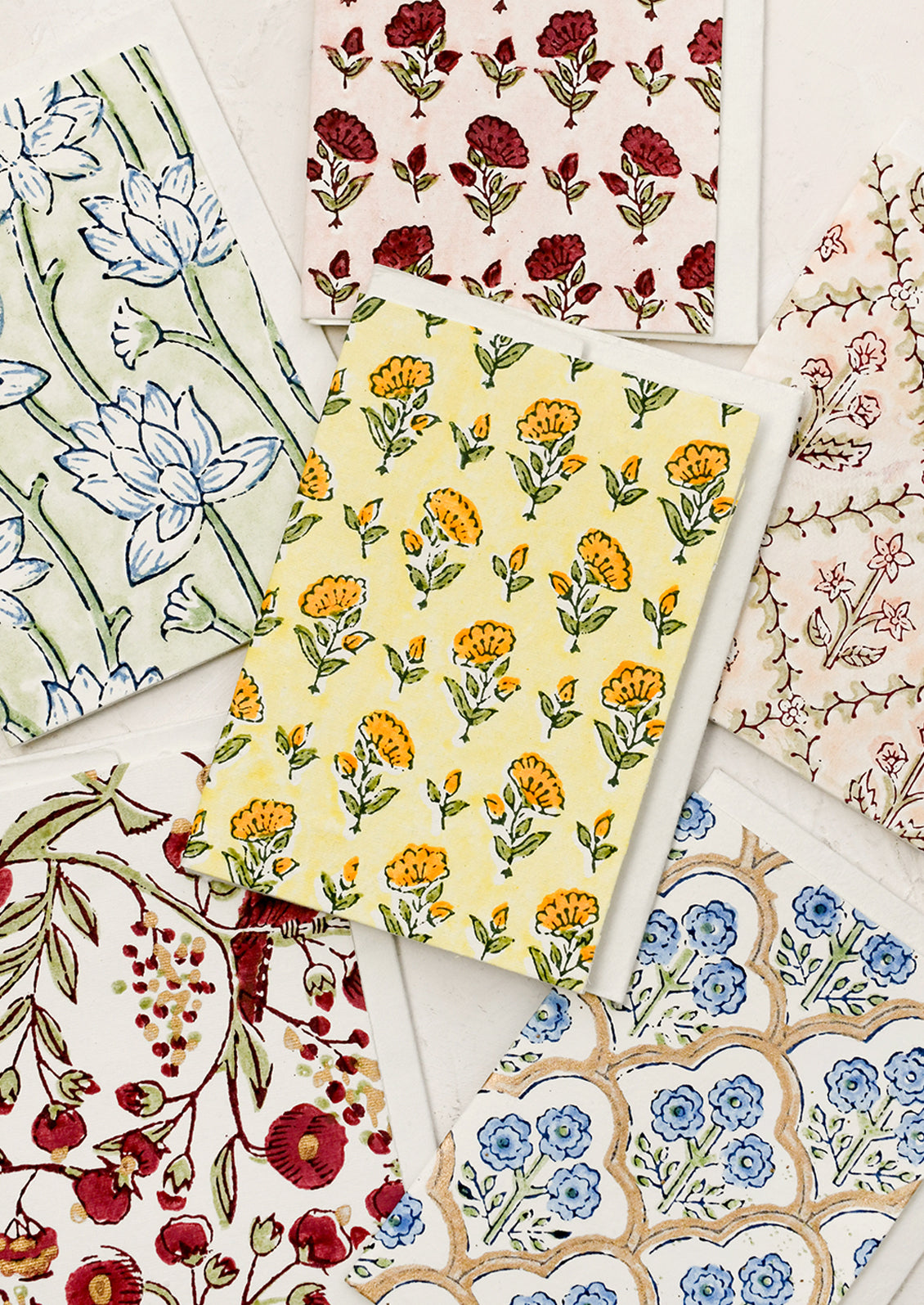 An assortment of block printed floral patterned cards.