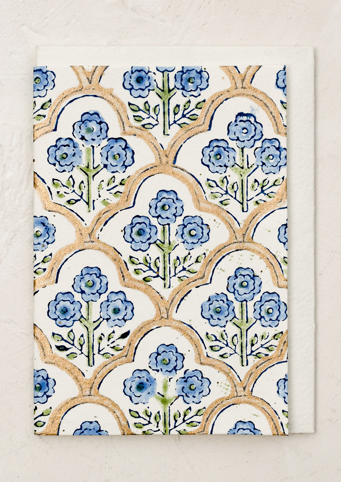A block printed floral card with matching lined envelope in blue colorway.