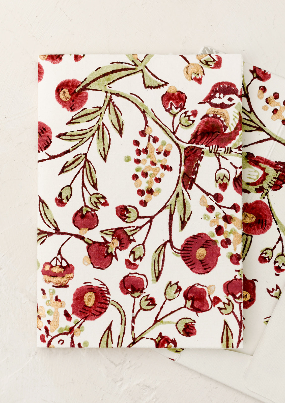 A block printed floral card with matching lined envelope in red bird pattern.