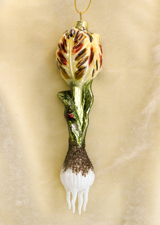 A glass ornament depicting a tulip bulb with ladybug detail.