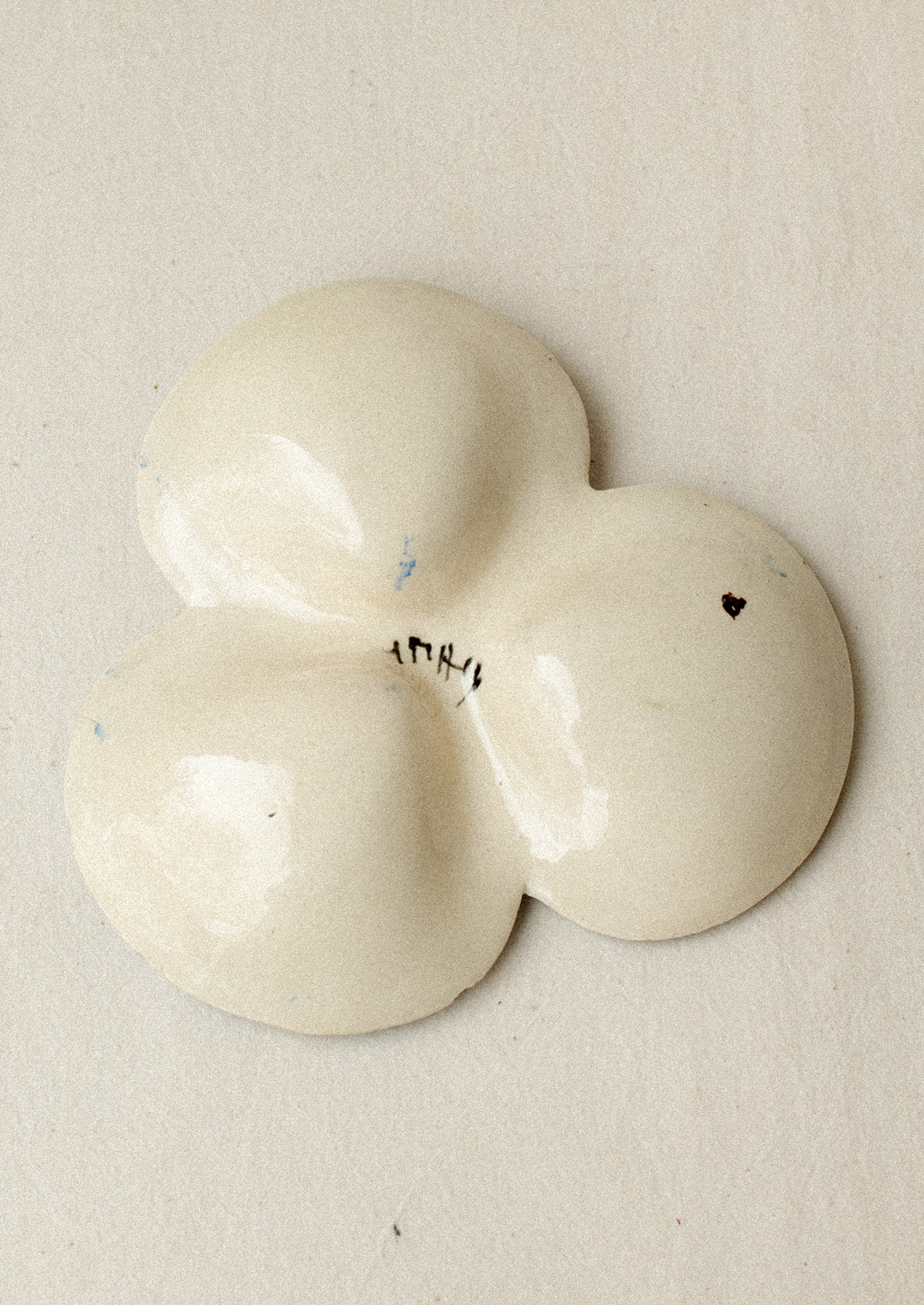 A triple well ceramic dish with hand painted floral pattern.