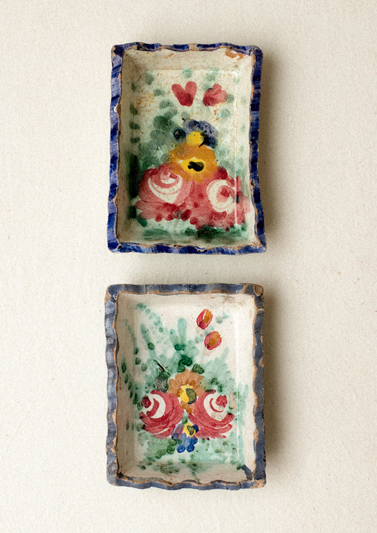Two small rectangular ceramic trays with floral designs.