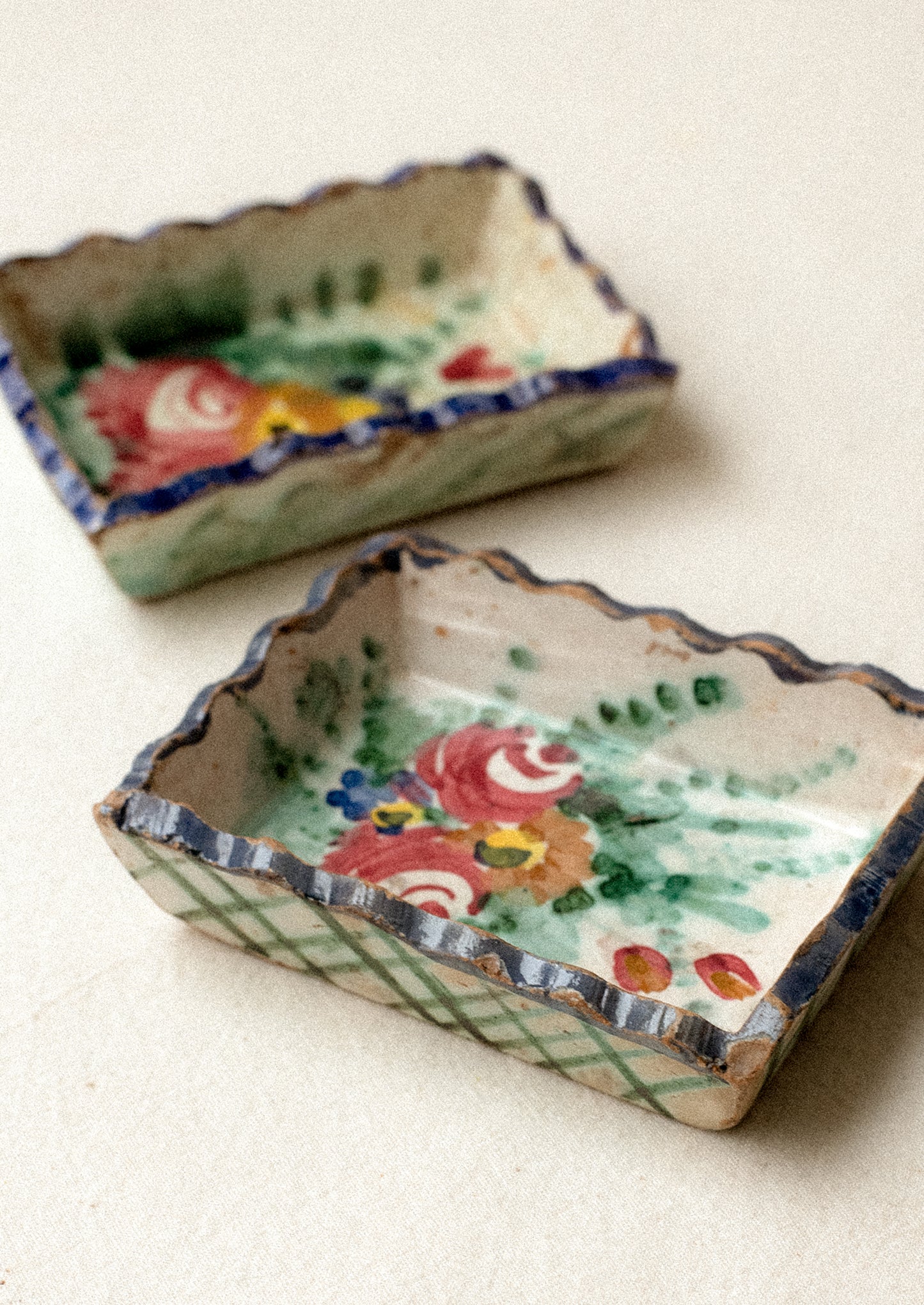 Two small rectangular ceramic trays with floral designs.
