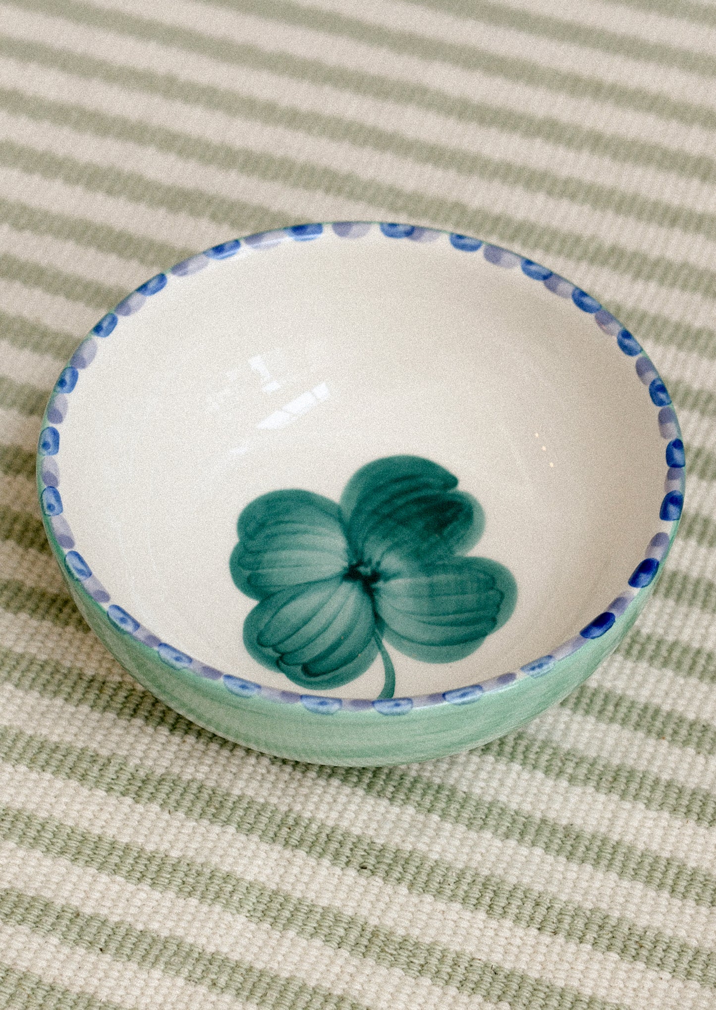 A ceramic bowl with clover motif.