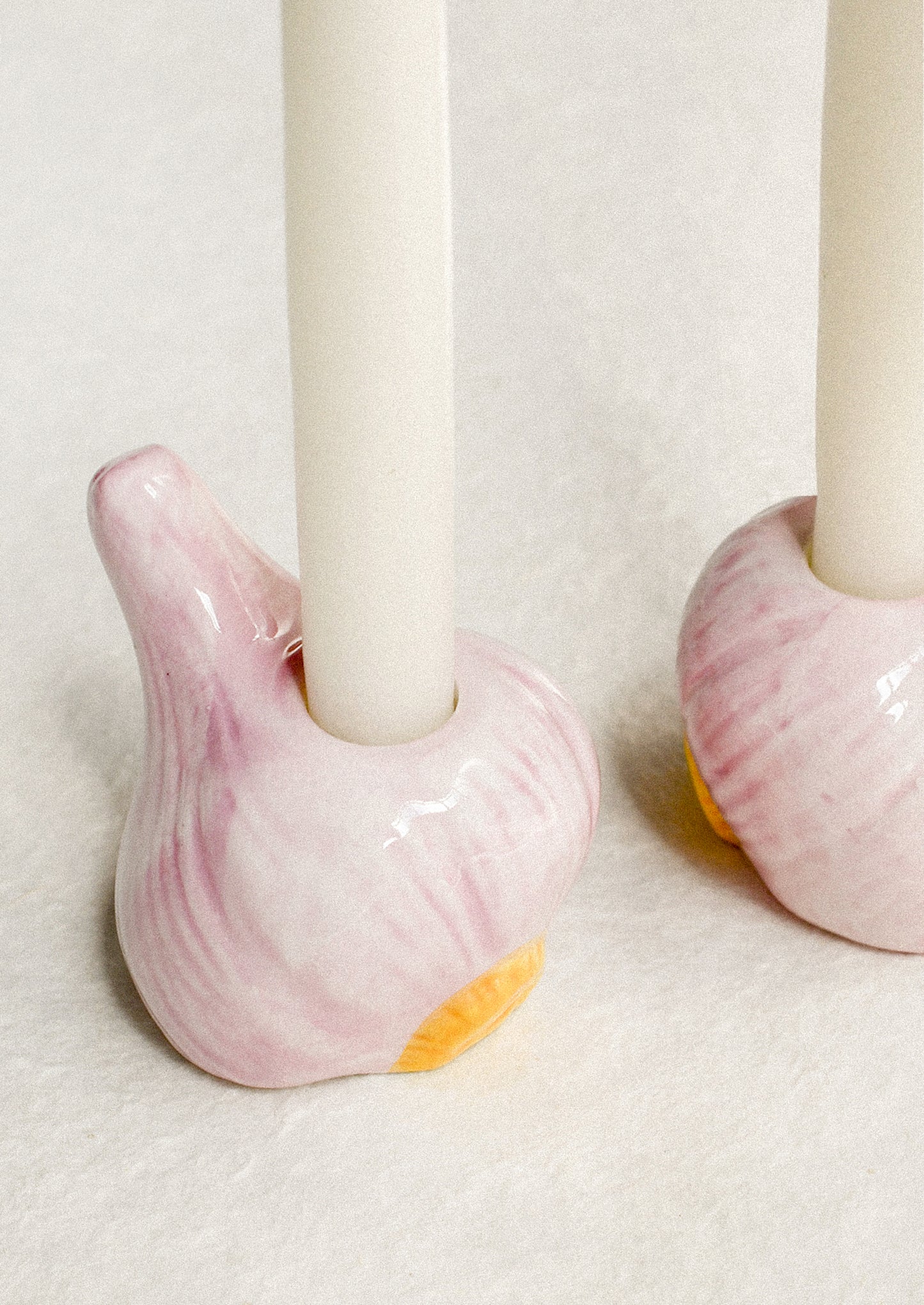 Ceramic candle holders in the shape of a bulb of garlic.