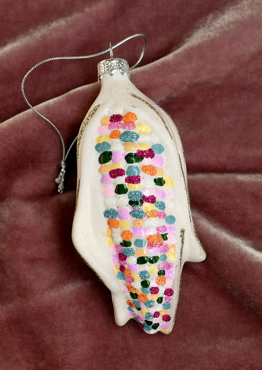 A glass ornament resembling colorful glass gem corn cob.