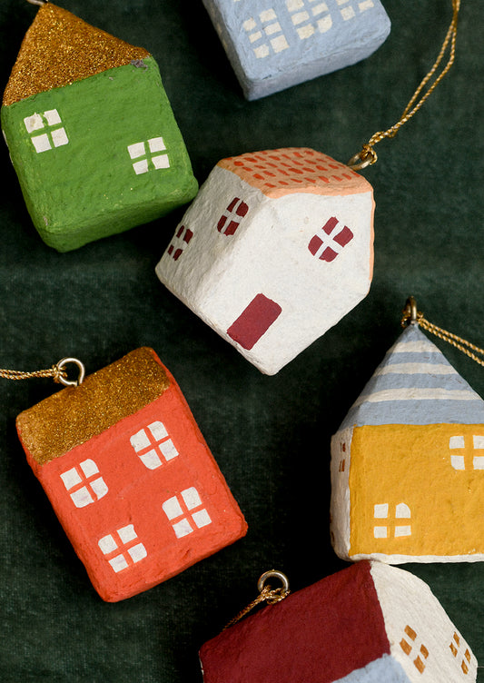 Colorful house-shaped ornaments on a dark green background