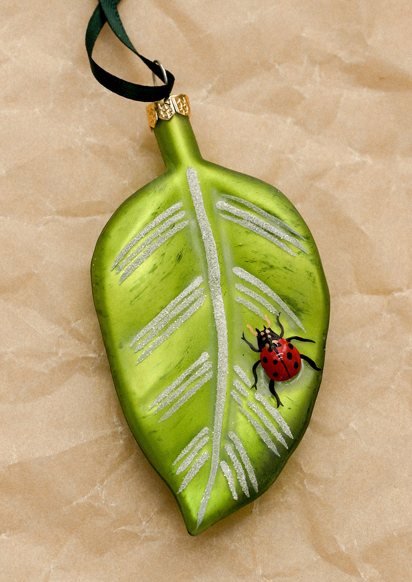 Decorative leaf ornament with a ladybug.