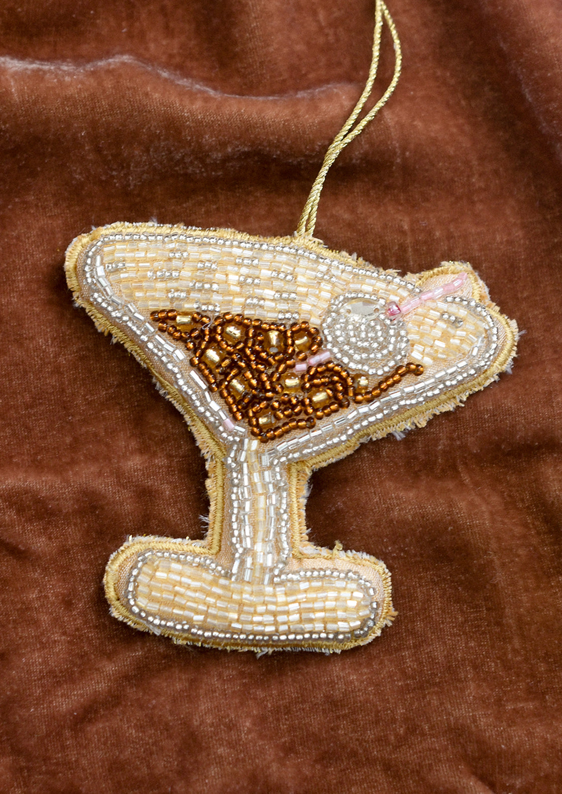 A decorative ornament in the shape of a martini with beaded embellishment.