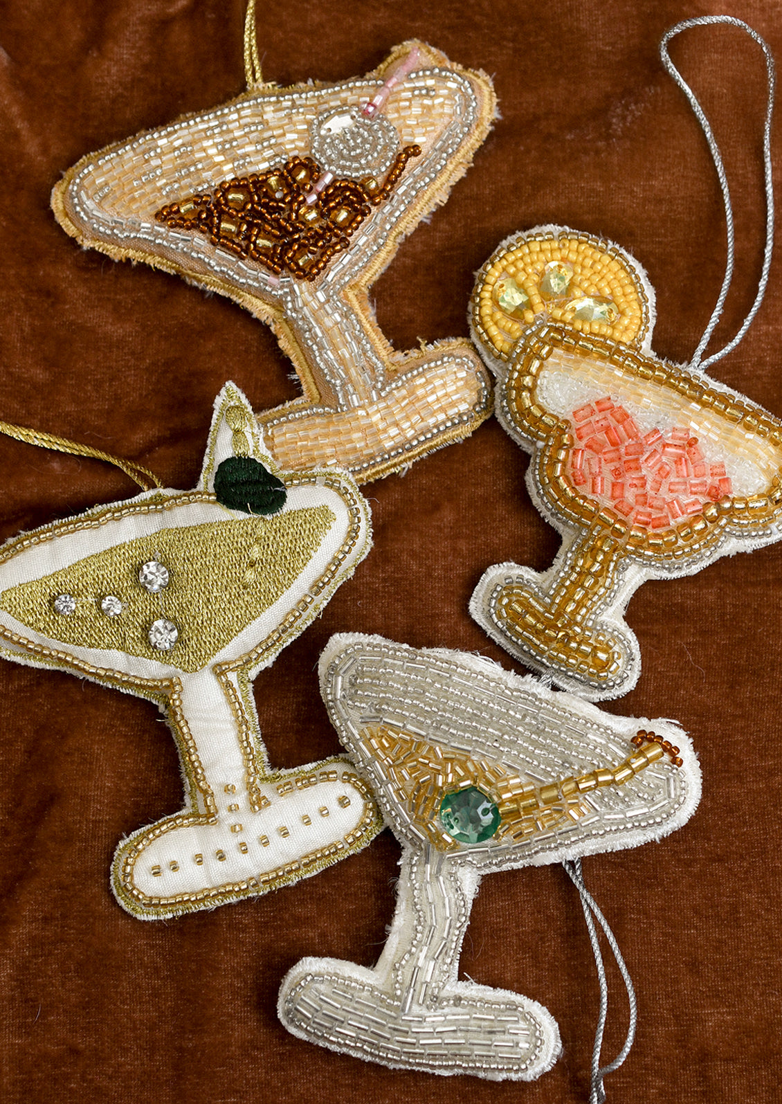 Decorative Christmas ornaments shaped like cocktail glasses.