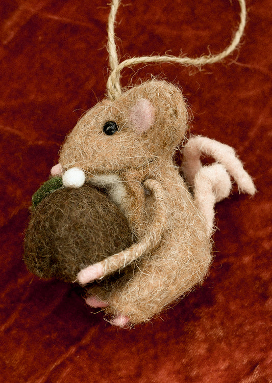 Felted brown mouse ornament holding pudding.