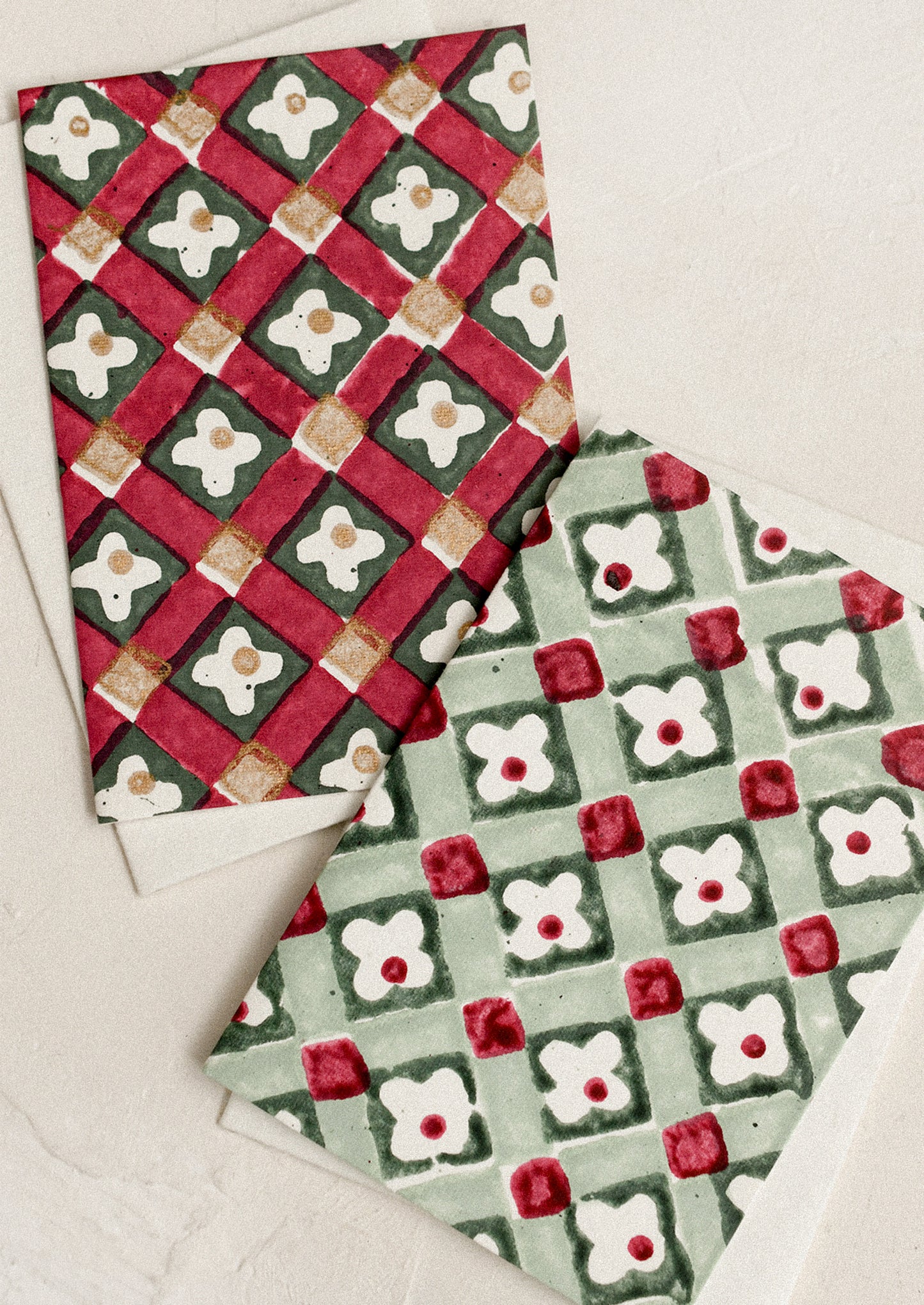 Red and green block printed greeting cards in floral check pattern.