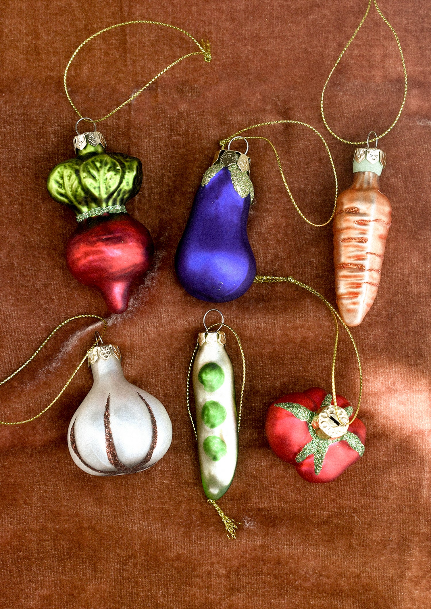 Set of colorful glass vegetable-shaped ornaments.