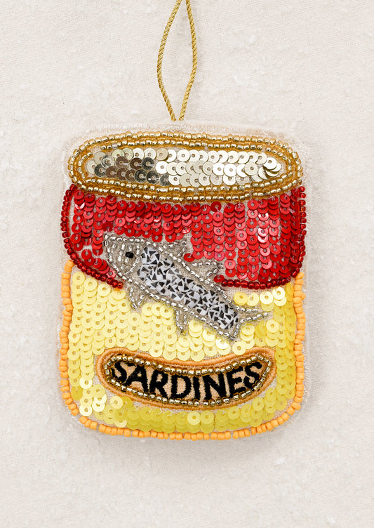 Sequined sardine can ornament with a fish.