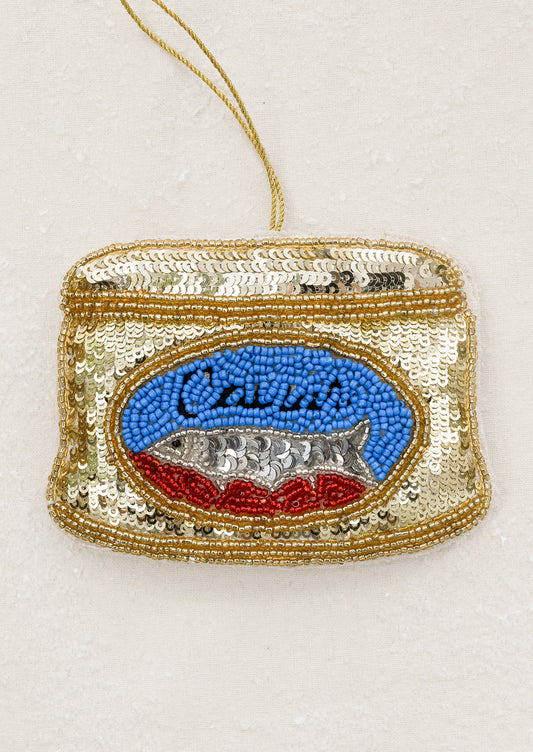 A sequin embroidered felt ornament depicting a can of caviar.