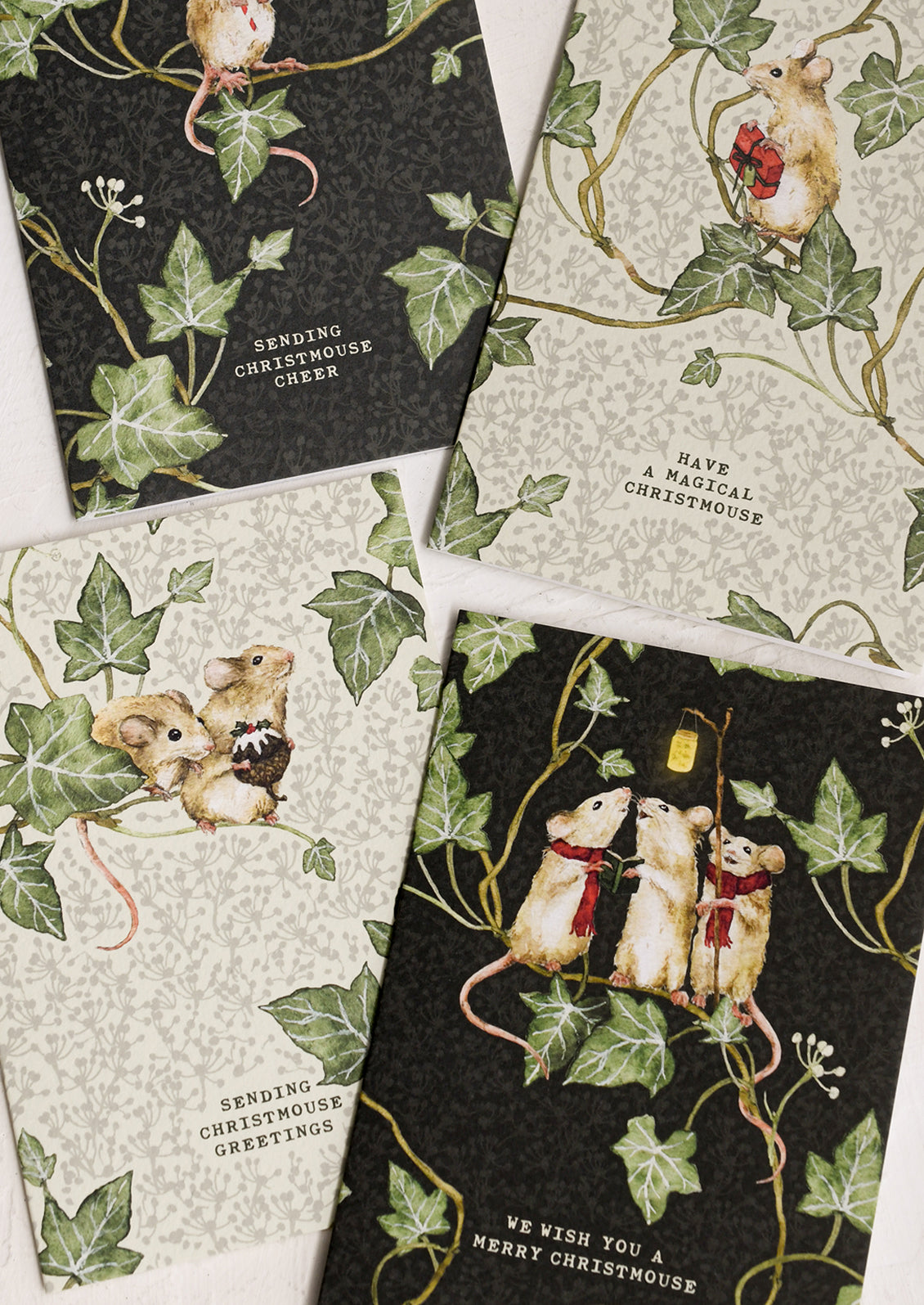 Set of Christmas-themed greeting cards with mice and ivy designs.