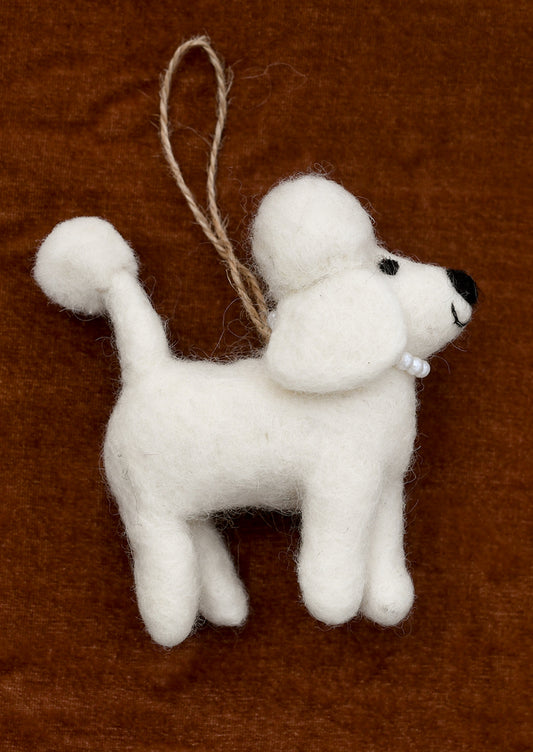A felted ornament depicting a white poodle wearing a pearl necklace.