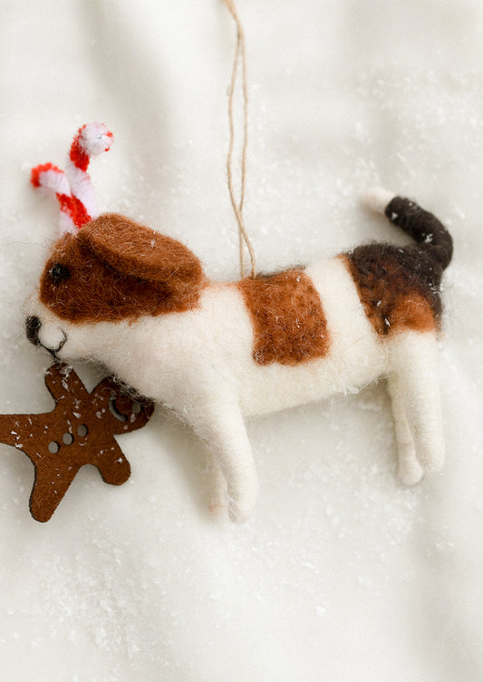 Felted dog ornament with candy cane ears and gingerbread cookie in mouth.