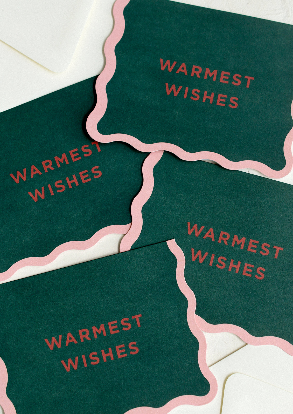 A set of green greeting cards with pink wavy border, text reads "Warmest Wishes".