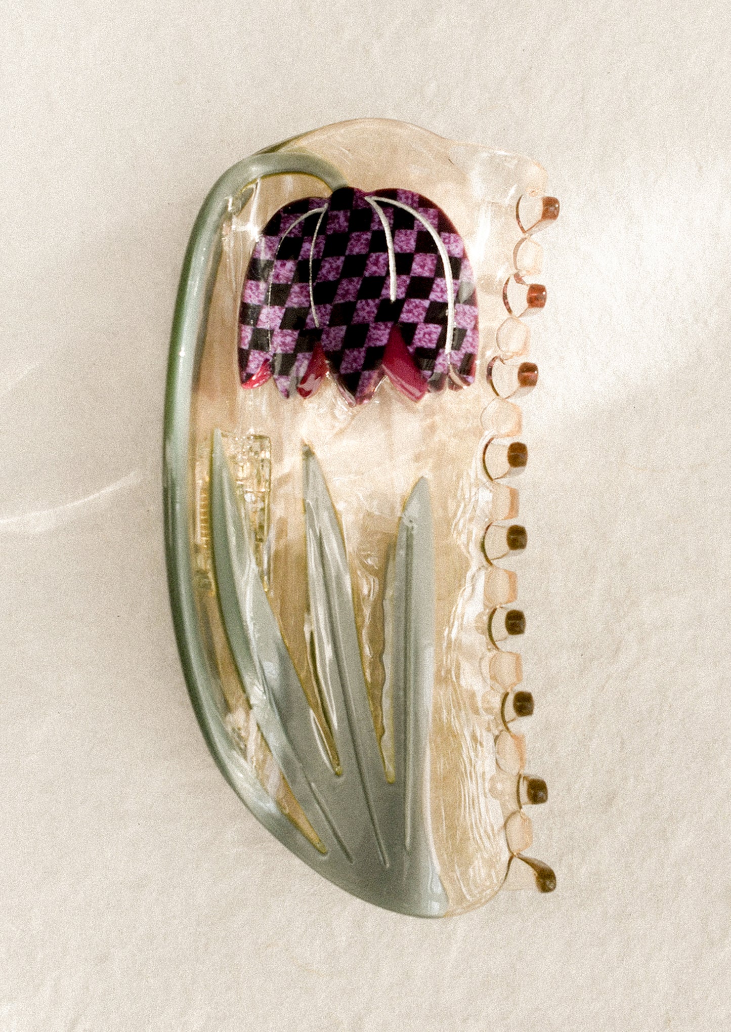 A decorative hair clip with frittalaria tulip pattern.