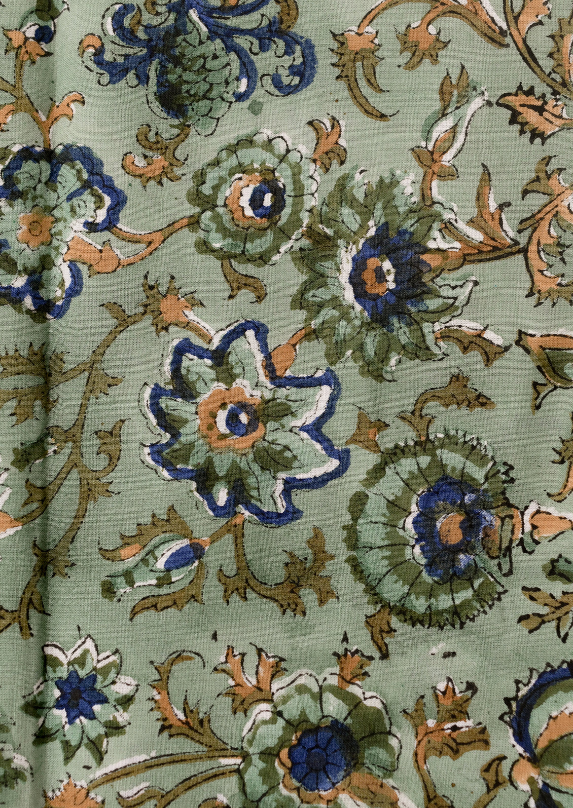 Folded green napkins with floral pattern on a white background