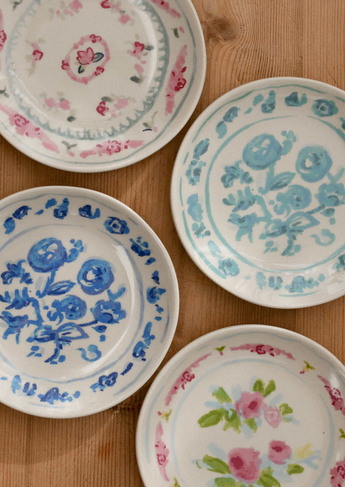 Decorative plates with floral patterns on a wooden surface.