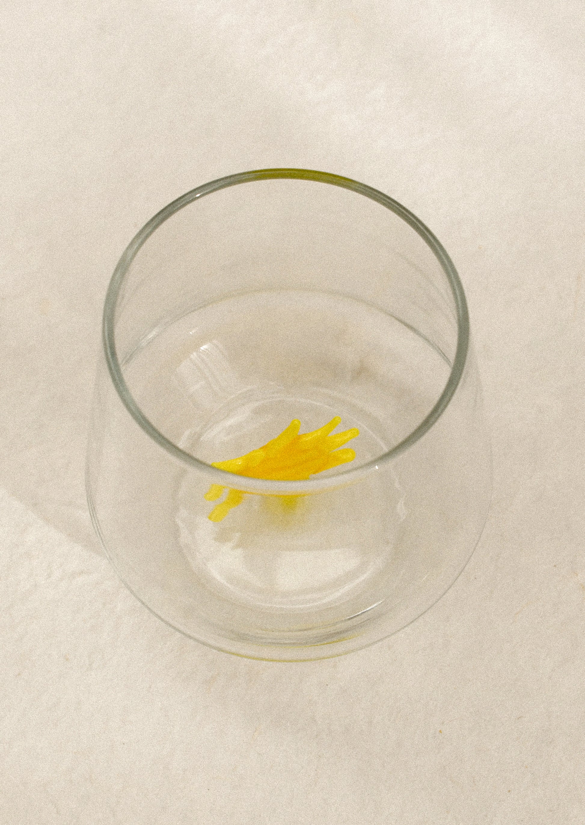 Clear glass with a yellow sun-shaped object on the inside.