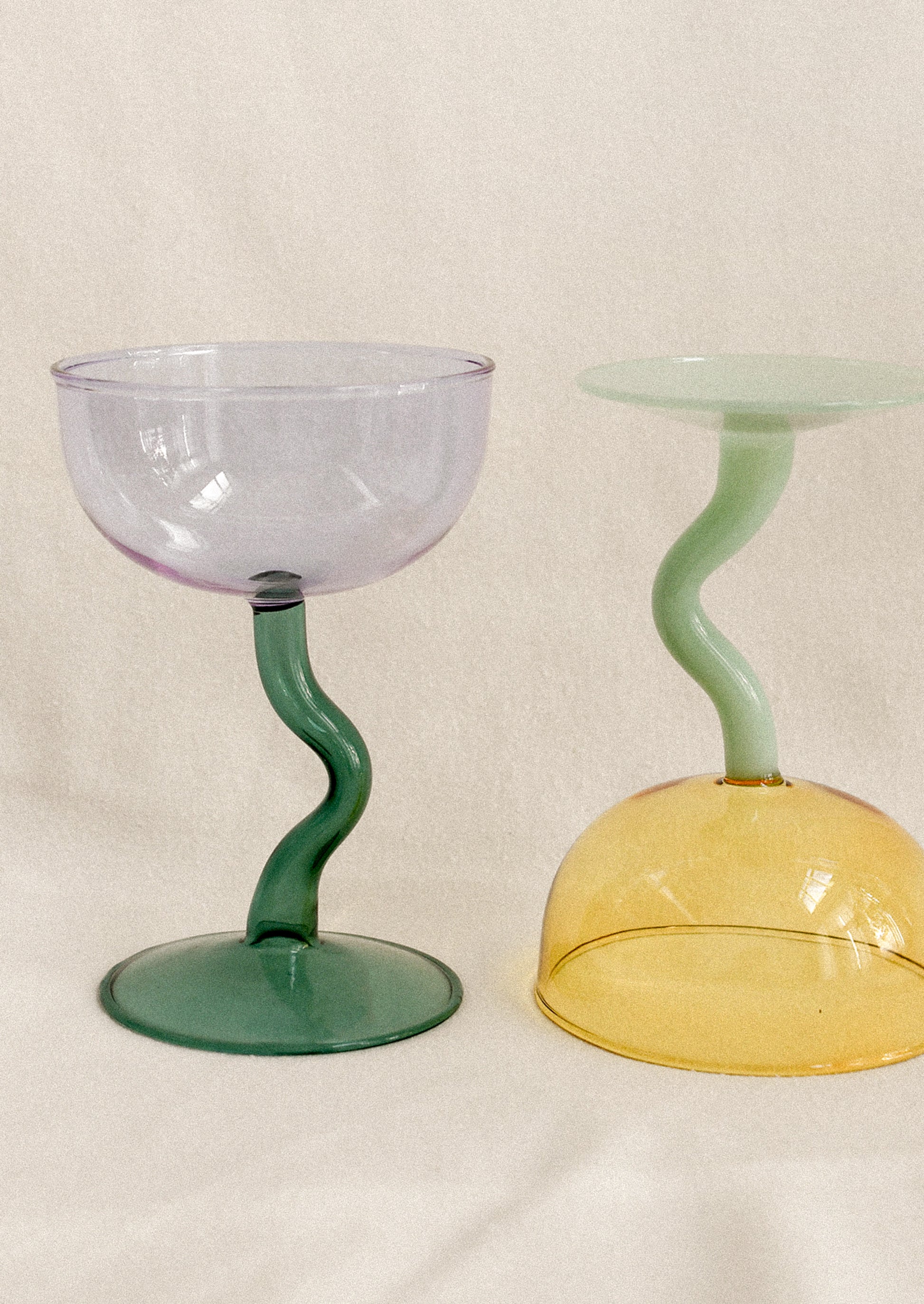 Coupe glasses with squiggle shaped handles.