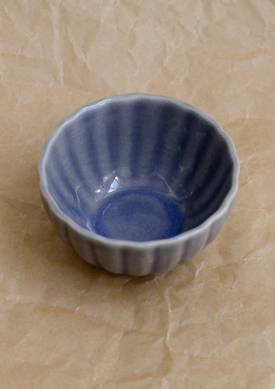 Blue ceramic bowl on a beige surface