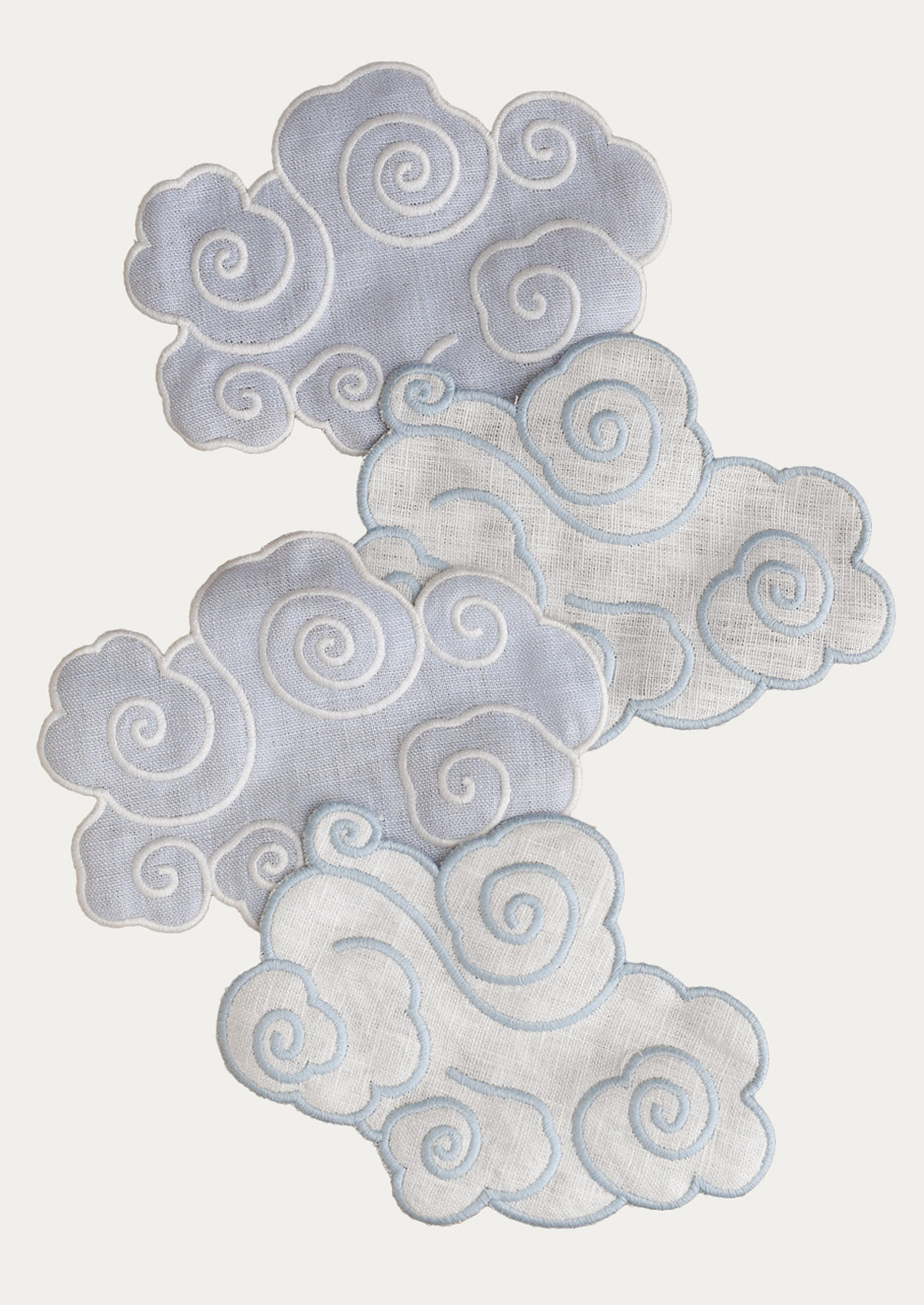 A set of four cloud-shaped linen cocktail napkins.