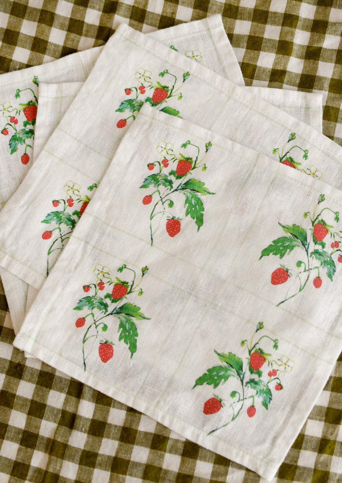 Set of 4 cocktail napkins with strawberry pattern.