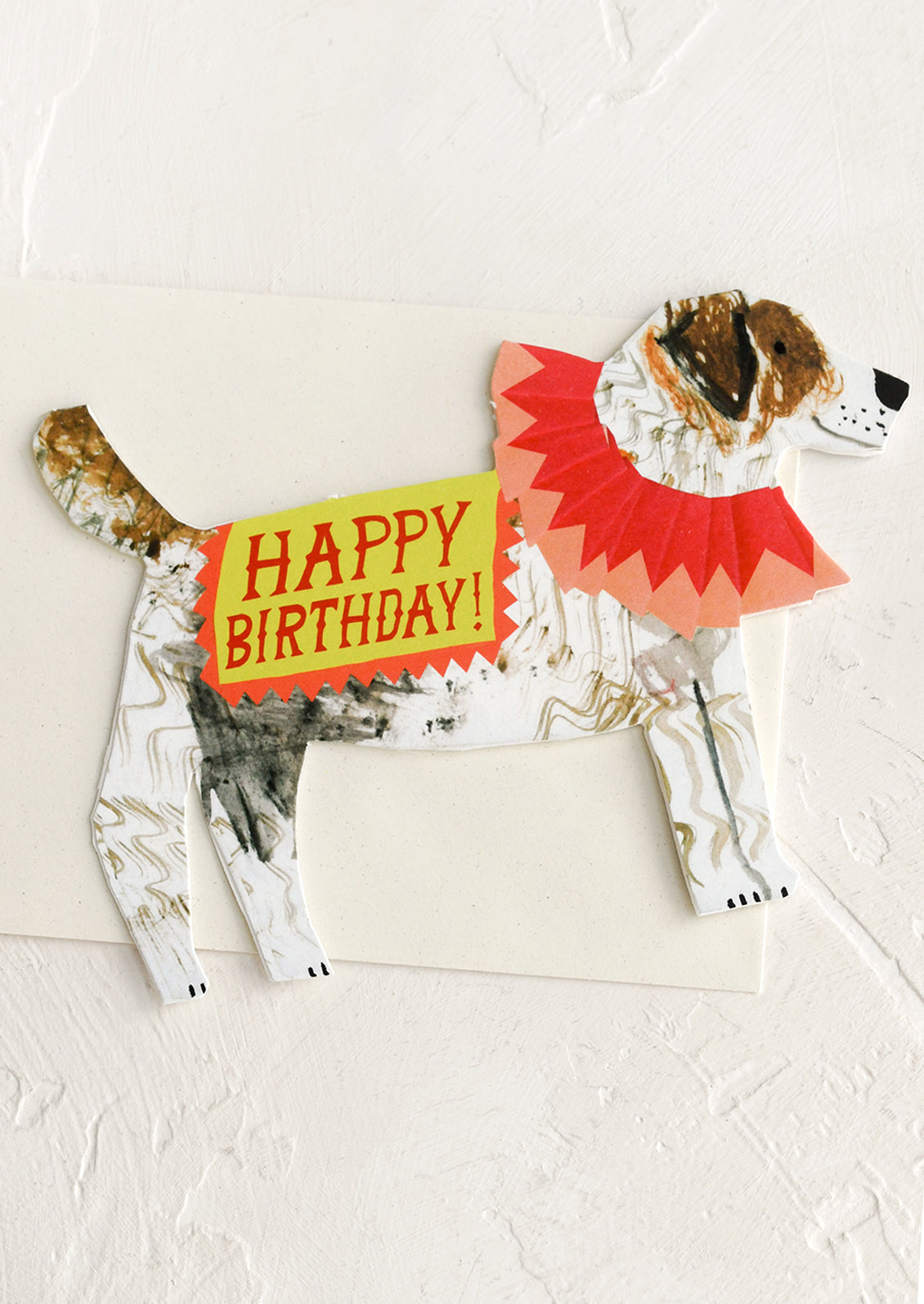 A diecut greeting card in the shape of a dog, text reads "Happy Birthday!".