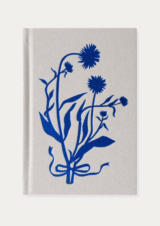 Cloth bound journal with blue floral design on a gray background