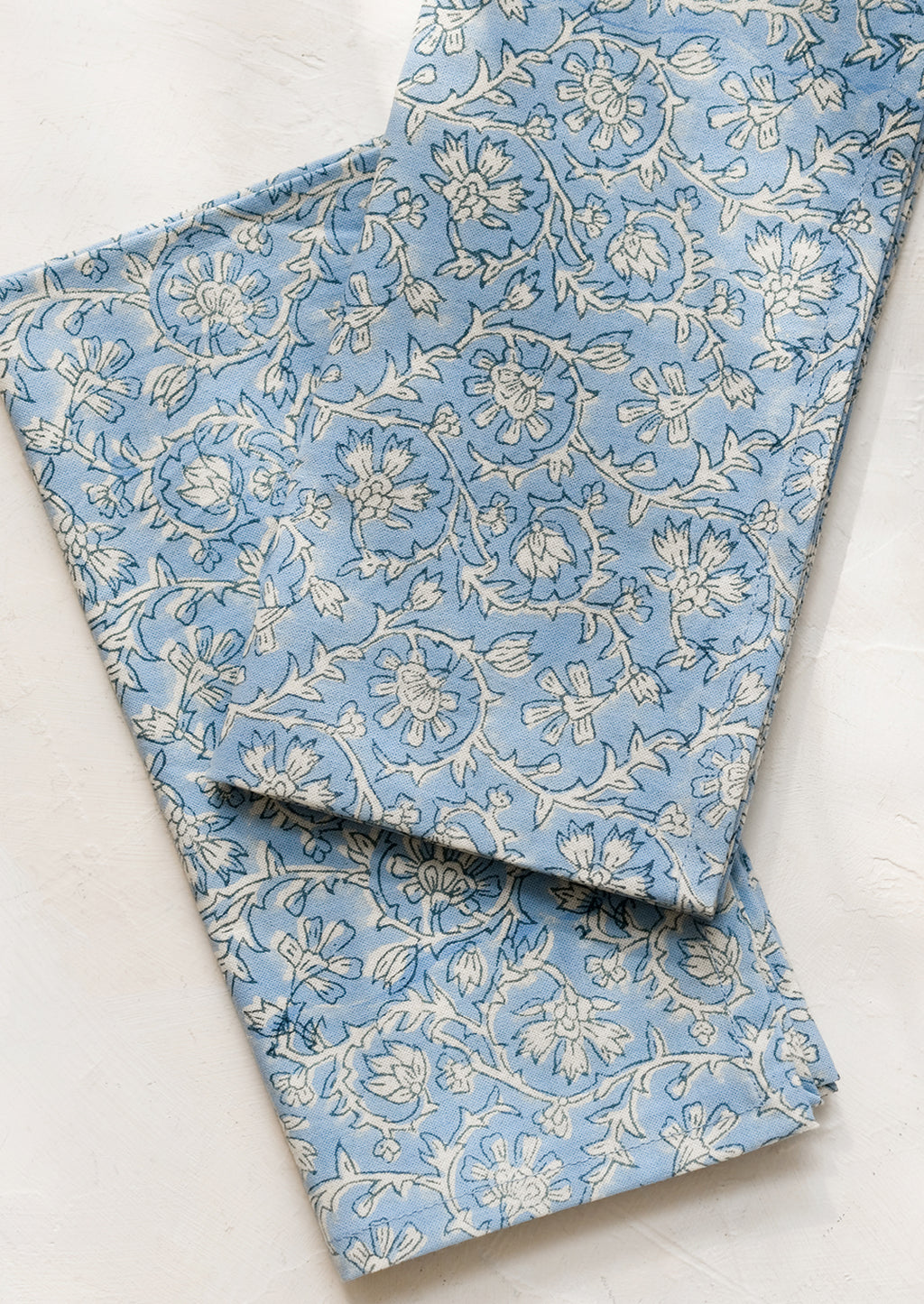 Cornflower Multi: A pair of blue and white colored napkins with floral print.