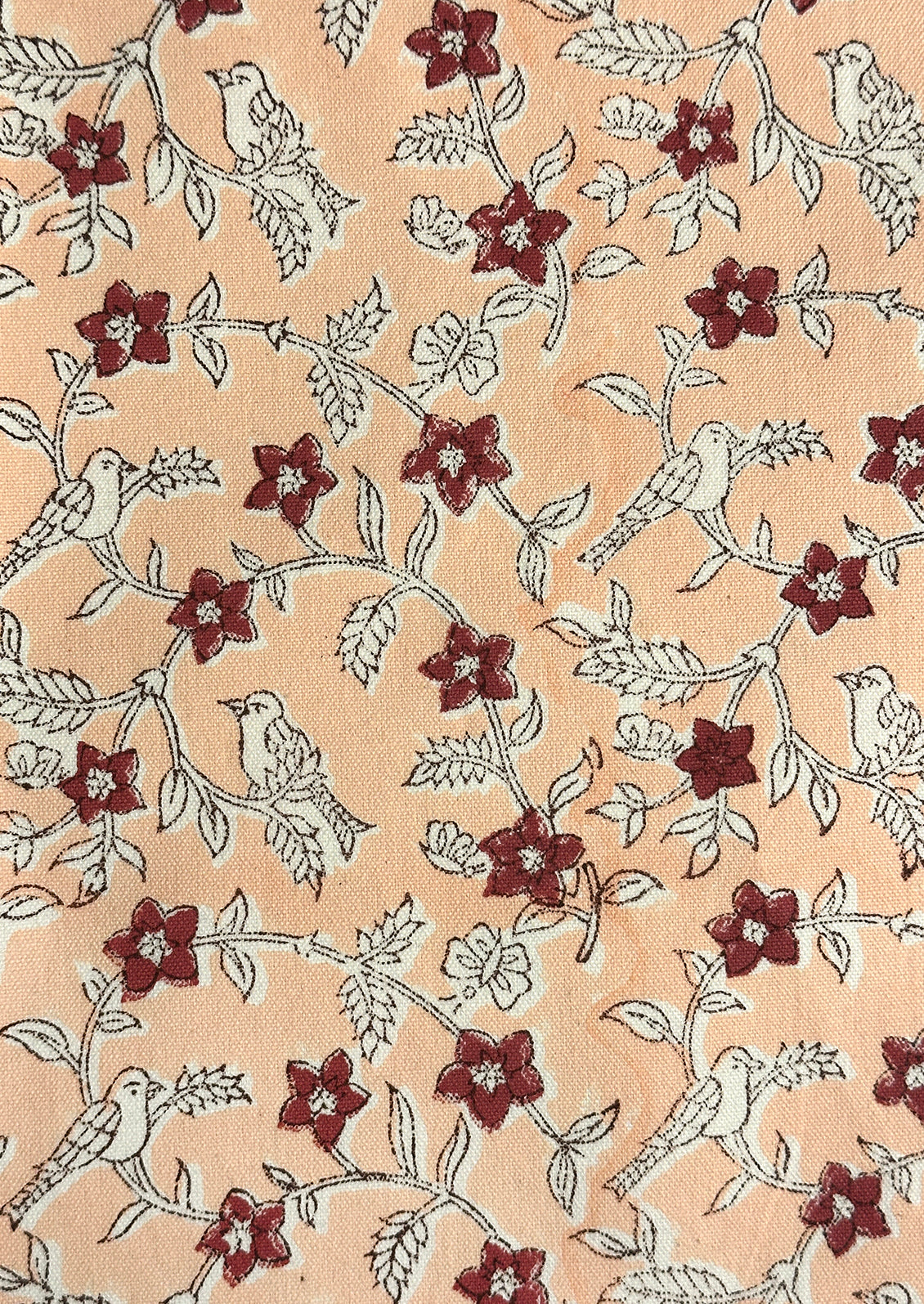 A patterned fabric with white birds and plum flowers.
