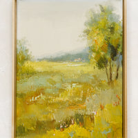 1: A framed oil landscape painting of a yellow-green meadow.