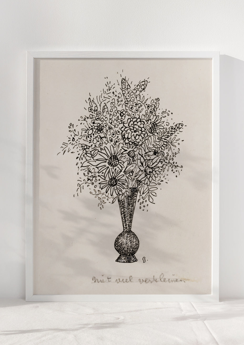 2: A vintage inspired art print in beige and black of sketch of flowers in vase, in white frame.