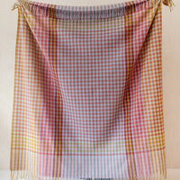 1: A colorful gingham check blanket in tones of lilac, magenta, and yellow.