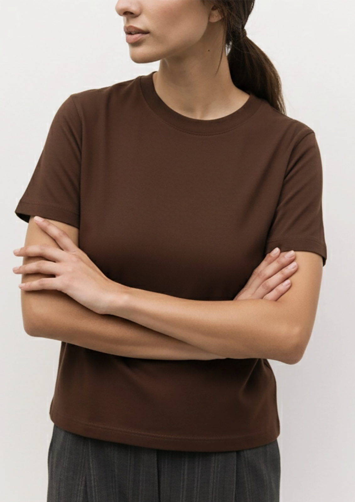 A woman wearing a brown short sleeve t-shirt.