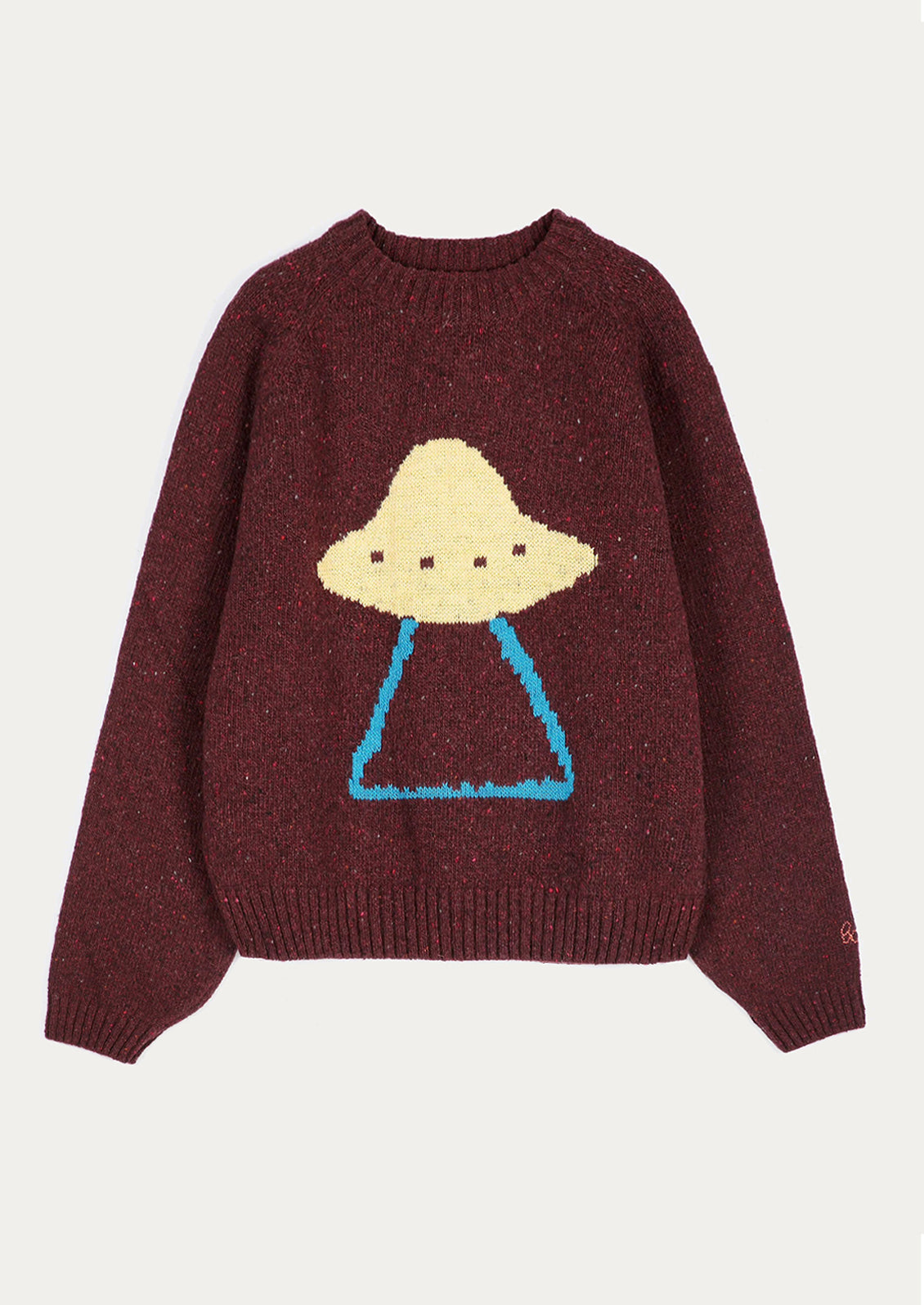 A dark burgundy knit sweater featuring a knitted graphic of a UFO with a beige dome-shaped head and blue legs, displayed against a light off-white background.