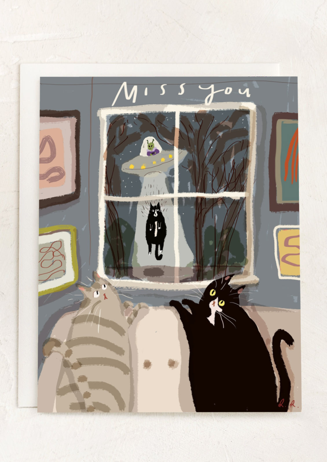 A greeting card with illustration of cats watching an alien abduction, text reads "miss you".