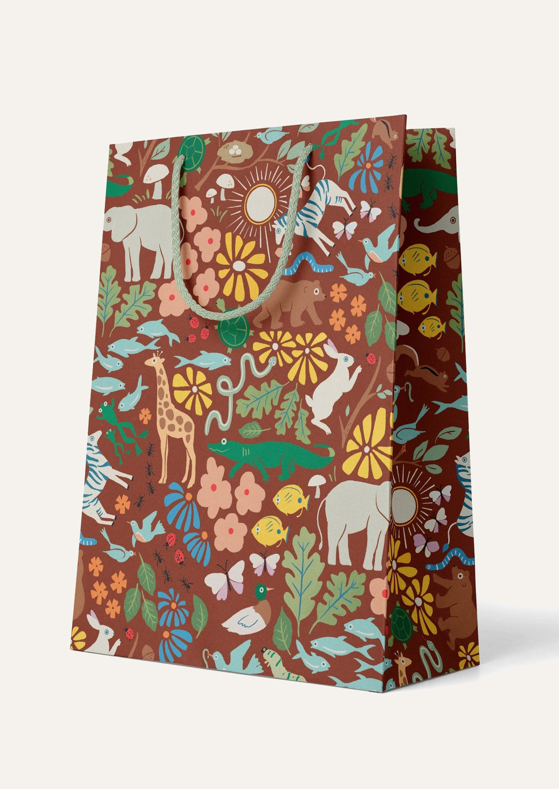 Gift bag with a colorful animal and floral pattern on a brown background.