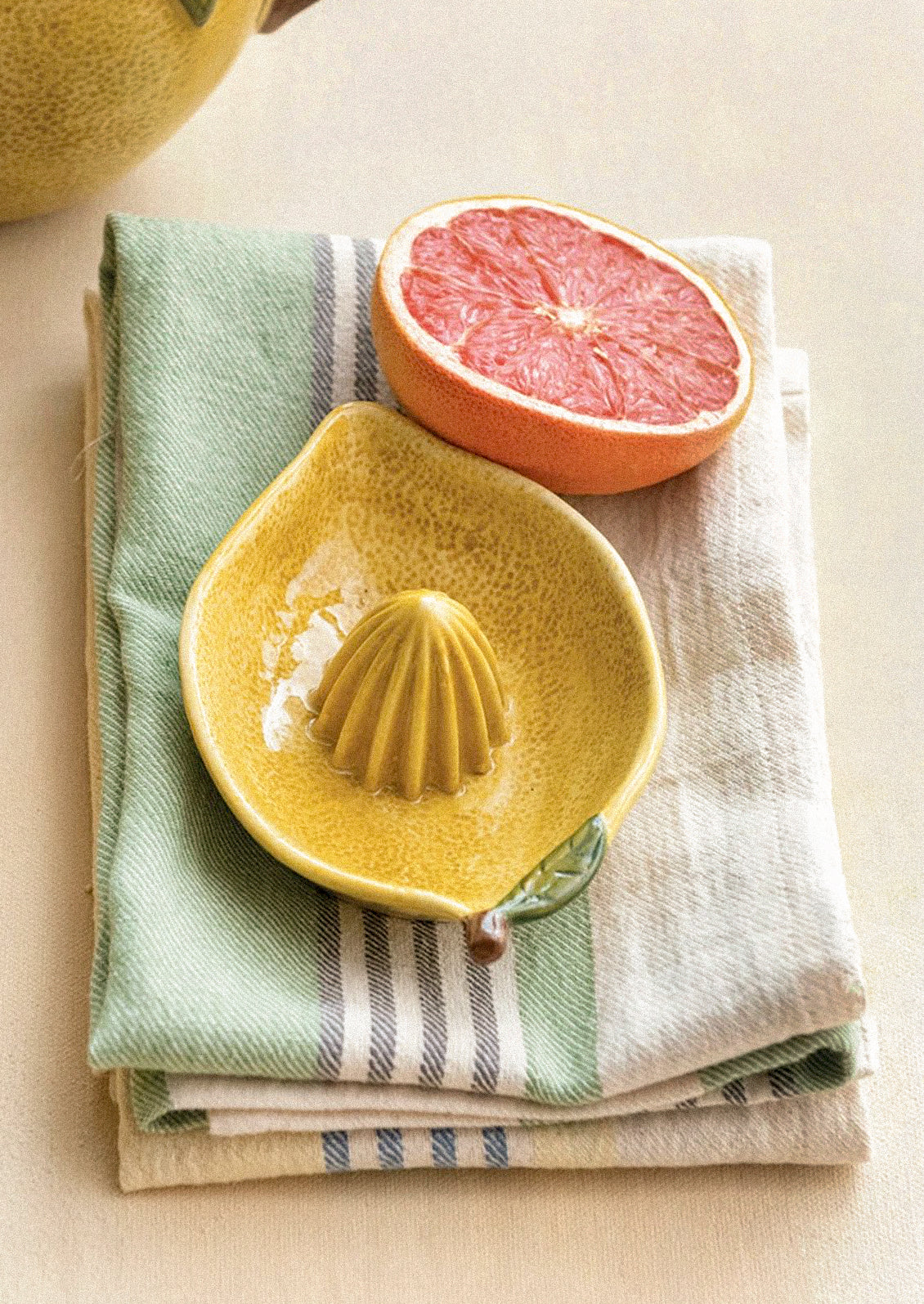 A ceramic citrus juicer in the shape of a lemon.