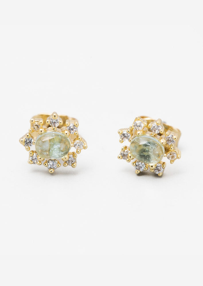 A pair of aquamarine and clear crystal gold stud earrings in sun shape.