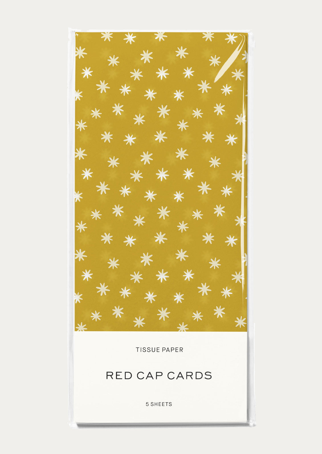 Tissue paper packaging with yellow and white star pattern on a white background