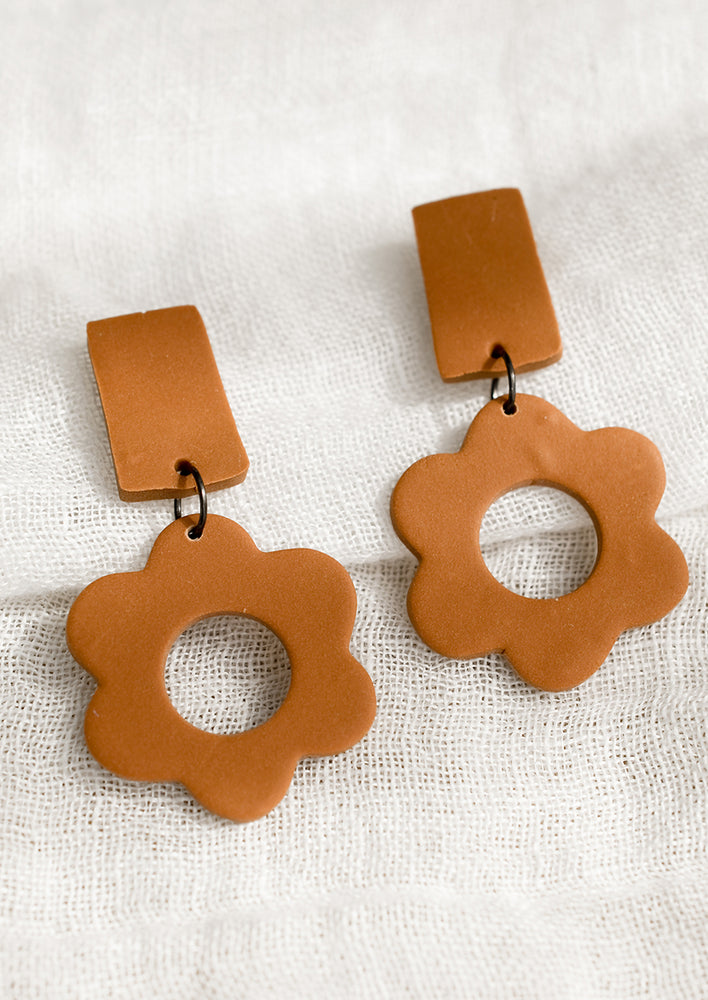 A pair of clay flower earrings with bar-shape post back in terracotta.