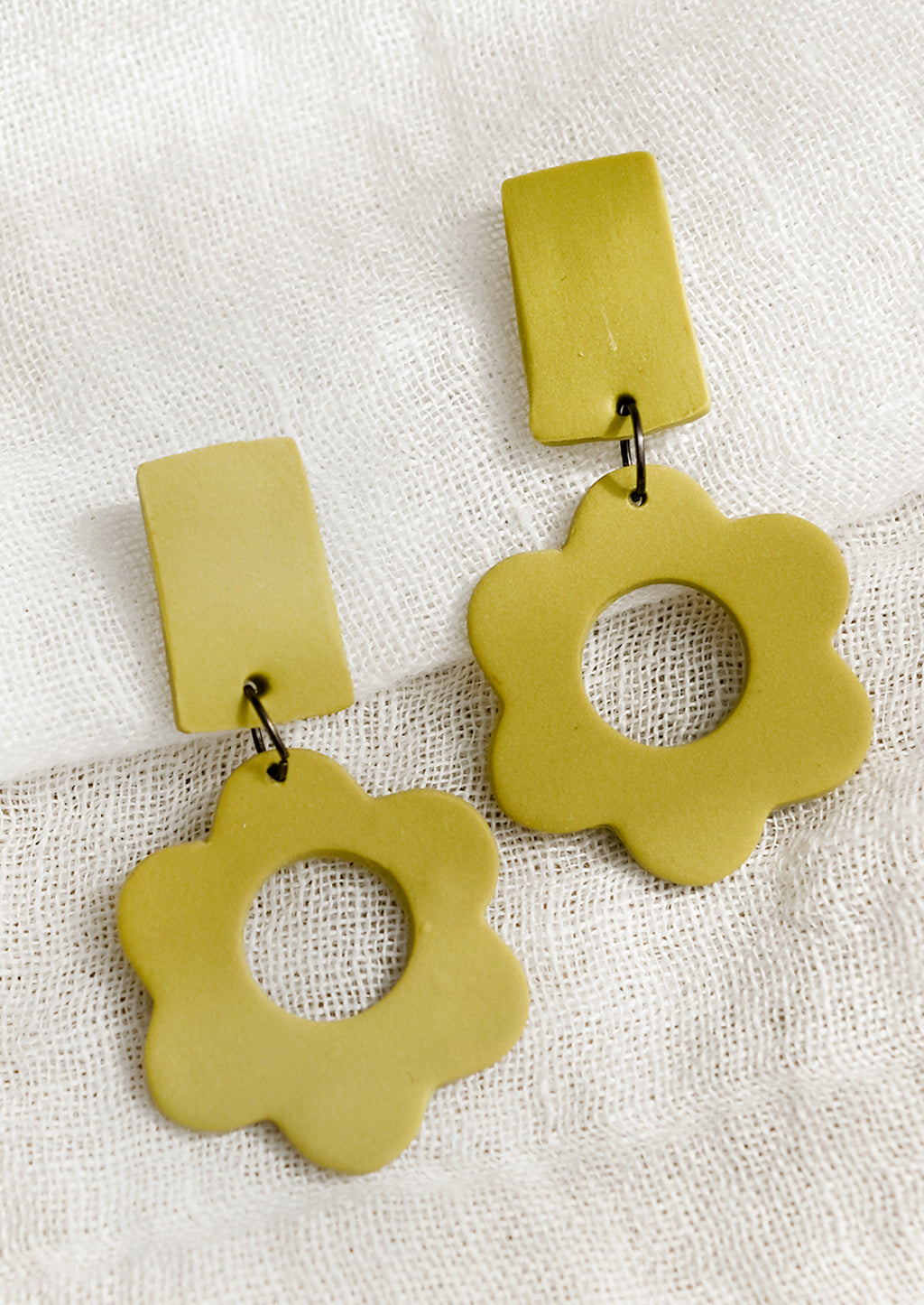 Split Pea: A pair of clay flower earrings with bar-shape post back in split pea.
